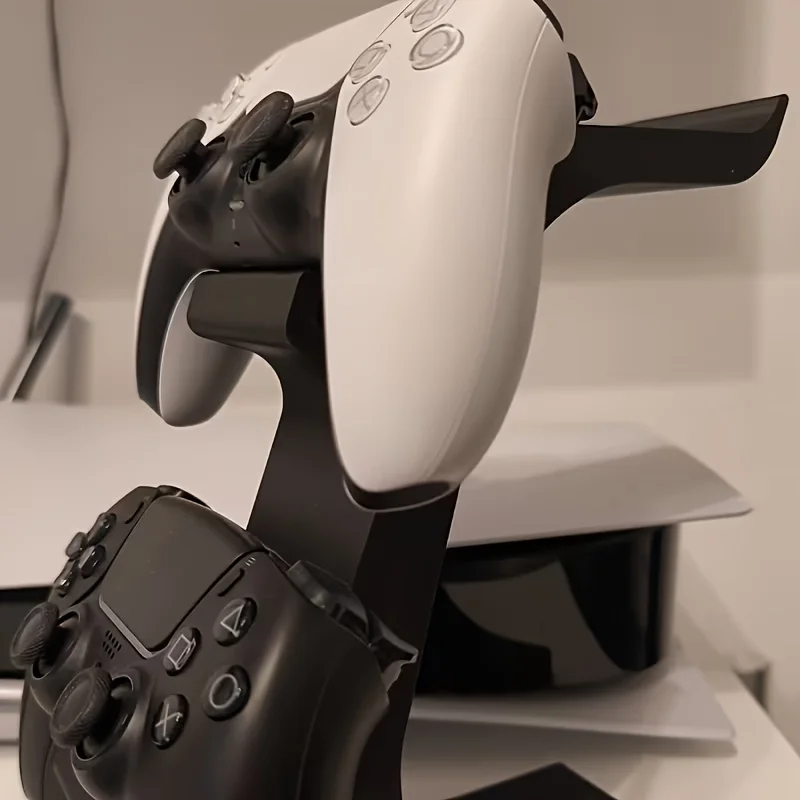 black 3-in-1 PS5 and Xbox Controller Stand – Compatible with PlayStation 5/Xbox Consoles. A gaming desktop organizer with a headphone hanger, non-charging base that holds 2 controllers and headphones. Space-saving white/black console accessory.